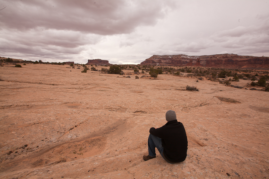 Tim DeChristopher on one of the parcels that he won in his act of civil disobedience at the December 19, 2008 BLM oil and gas auction. This is the first time was on the parcels that he won. These parcels were later pulled from being auctionable by the Obama administration. These three parcels pictured here are across the street from Arches National Park. : Tim DeChristopher : Sallie Dean Shatz