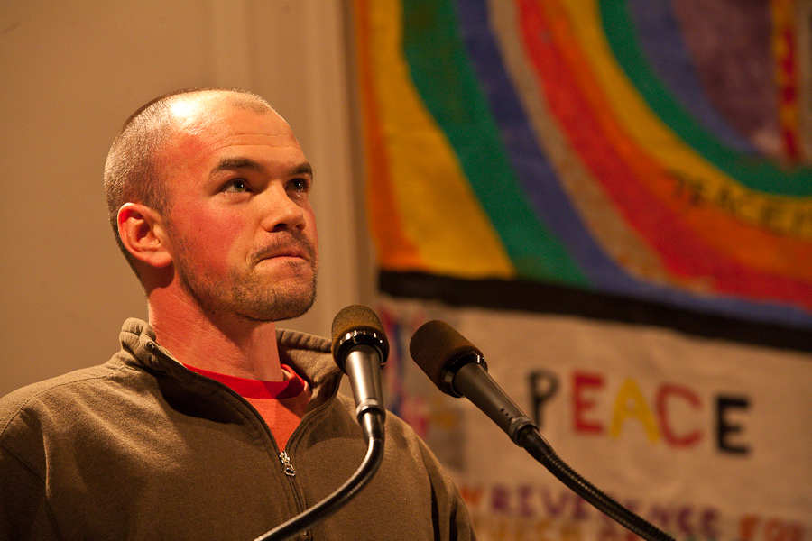 Tim DeChristopher in one of his first public speeches blushes in response to the standing ovation by concerned citizens at the First Unitarian Church of Salt Lake City, a month after his act of civil disobedience at the BLM oil and gas lease auction December 19th, 2008. The forum's title "Is Civil Disobedience A Moral Imperative In This Time? Speakers were DeChristopher, Former Salt Lake City Mayoer Rocky Anderson, activist Michael Milke, and University of Utah's scientists. : Tim DeChristopher : Sallie Dean Shatz